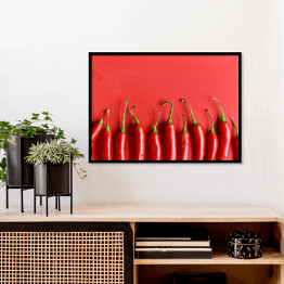 Plakat w ramie Czerwona papryka chili na czerwonym tle