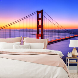Most Golden Gate na tle wody w różowych barwach oraz złocisto błękitnego nieba