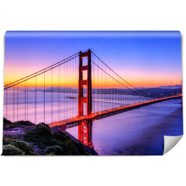 Fototapeta samoprzylepna Most Golden Gate na tle wody w różowych barwach oraz złocisto błękitnego nieba