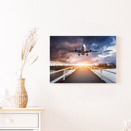Obraz na płótnie Samolot i drewniany most o zachodzie słońca