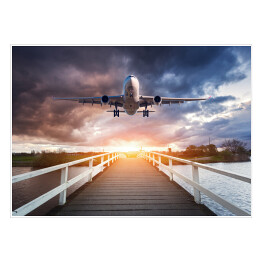 Plakat Samolot i drewniany most o zachodzie słońca