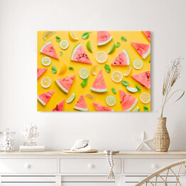 Obraz na płótnie Cytryny i limonki z arbuzem na żółtym tle