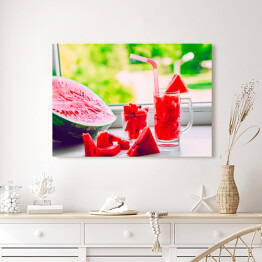 Obraz na płótnie Szklanka ze słomkami i sokiem z arbuza na parapecie