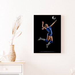 Obraz na płótnie Kobieta grająca w siatkówkę na czarnym tle