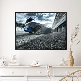 Obraz w ramie Czarno niebieski sportowy samochód na torze wyścigowym