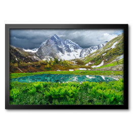 Obraz w ramie Jezioro w górach Arkhyz - piękny krajobraz z ośnieżonymi górami, jeziorem i pochmurnym niebem
