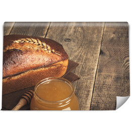 Fototapeta Domowej roboty żytni chleb i szklany słój z miodem