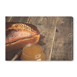 Obraz na płótnie Domowej roboty żytni chleb i szklany słój z miodem