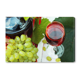 Obraz na płótnie Kieliszek wina i winogrona na stole