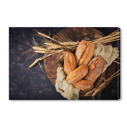 Obraz na płótnie Chleb i bułki na drewnianym tle - widok z góry