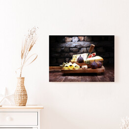 Obraz na płótnie Różne sery na desce na drewnianym stole