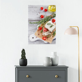 Plakat samoprzylepny Świeży ser feta z rozmarynem na białej drewnianej desce