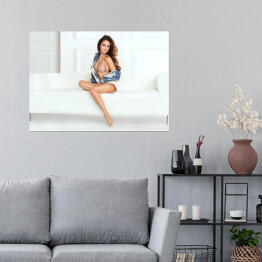 Plakat Piękna kobieta z długimi nogami pozująca siedząc