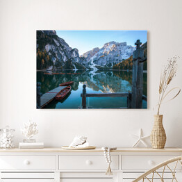 Obraz na płótnie Idylliczne górskie jezioro z pomostem i łodziami przed malowniczym skalistym krajobrazem