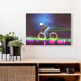 Obraz na płótnie Rowerzysta jadący nocą na neonowym rowerze