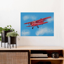 Czerwony samolot lecący po błękitnym niebie