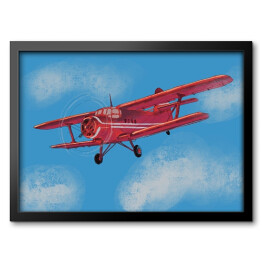 Obraz w ramie Czerwony samolot lecący po błękitnym niebie