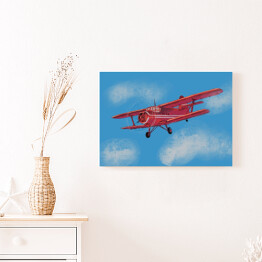 Obraz na płótnie Czerwony samolot lecący po błękitnym niebie