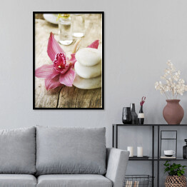 Plakat w ramie Jasne kamienie do masażu i różowy piękny kwiat