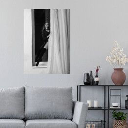 Plakat samoprzylepny Czarno biała fotografia kobiety w oknie