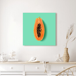 Przekrojona papaya na miętowym tle