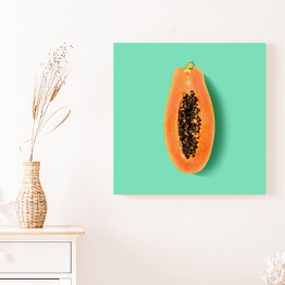 Obraz na płótnie Przekrojona papaya na miętowym tle