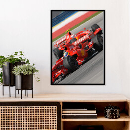 Plakat w ramie Czerwone sportowe auto Ferrari oświetlone promieniami słońca