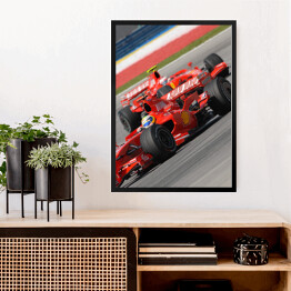Obraz w ramie Czerwone sportowe auto Ferrari oświetlone promieniami słońca