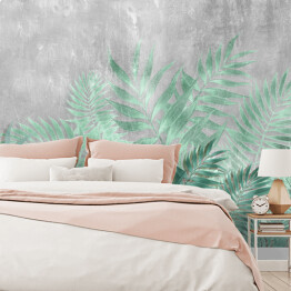 Fototapeta Tropikalne liście palmowe w turkusowych barwach na tle imitującym beton