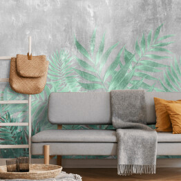 Fototapeta winylowa zmywalna Tropikalne liście palmowe w turkusowych barwach na tle imitującym beton