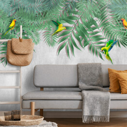 Kolorowe papugi w wiszących liściach palmy na tle imitacji betonu