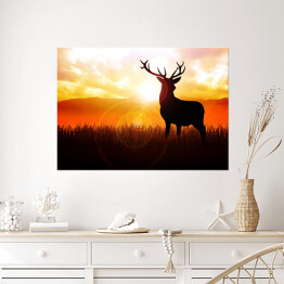 Plakat samoprzylepny Postać jelenia na tle zachodzącego słońca