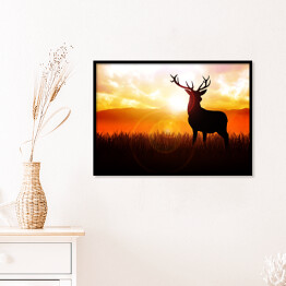Plakat w ramie Postać jelenia na tle zachodzącego słońca