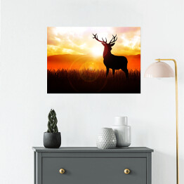 Plakat samoprzylepny Postać jelenia na tle zachodzącego słońca