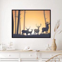 Plakat w ramie Dzikie zwierzęta w lesie na tle zachodzącego słońca
