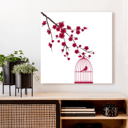 Obraz na płótnie Czerwony ptak w klatce na gałęzi z kwiatami