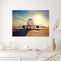 Plakat Duży samolot na tle wschodu słońca