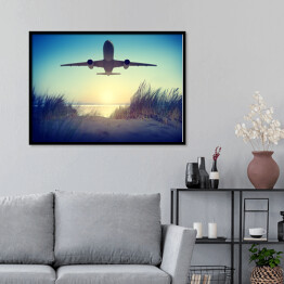 Plakat w ramie Samolot lecący nad plażą