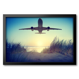 Obraz w ramie Samolot lecący nad plażą
