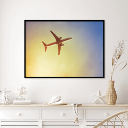 Plakat w ramie Samolot przecinający promienie słońca
