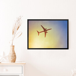 Obraz w ramie Samolot przecinający promienie słońca