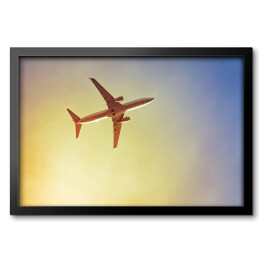 Obraz w ramie Samolot przecinający promienie słońca