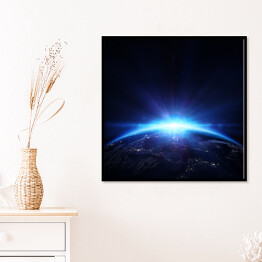 Plakat w ramie Planeta Ziemia z wschodem słońca w przestrzeni 