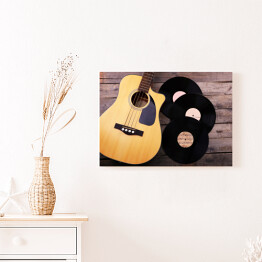 Obraz na płótnie Gitara i winylowe płyty na drewnianym stole