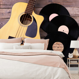 Fototapeta winylowa zmywalna Gitara i winylowe płyty na drewnianym stole