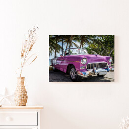 Obraz na płótnie Różowy retro samochód przy tropikalnej plaży
