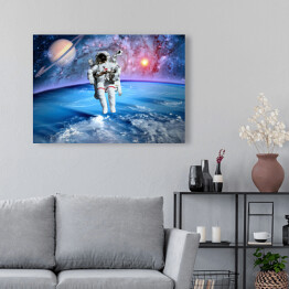 Obraz na płótnie Astronauta oraz Saturn we Wszechświecie