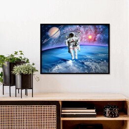 Plakat w ramie Astronauta oraz Saturn we Wszechświecie