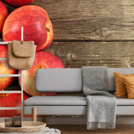 Fototapeta Dojrzałe jabłka na tle imitującym drewno