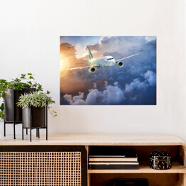 Plakat Samolot wśród chmur w blasku słońca